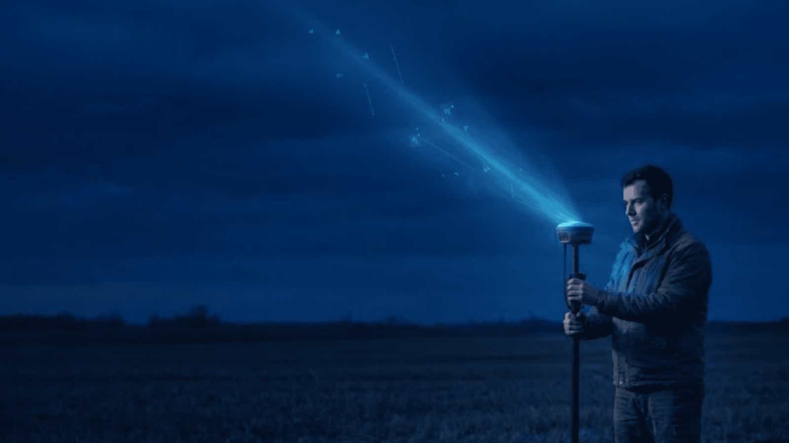 Handheld weather sensor measuring atmospheric conditions at night.