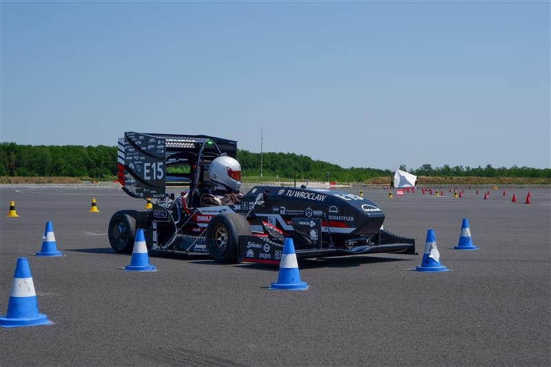 PWR Racing Team RT15e car between cones on a Formula Student Skidpad track at TU Wrocław