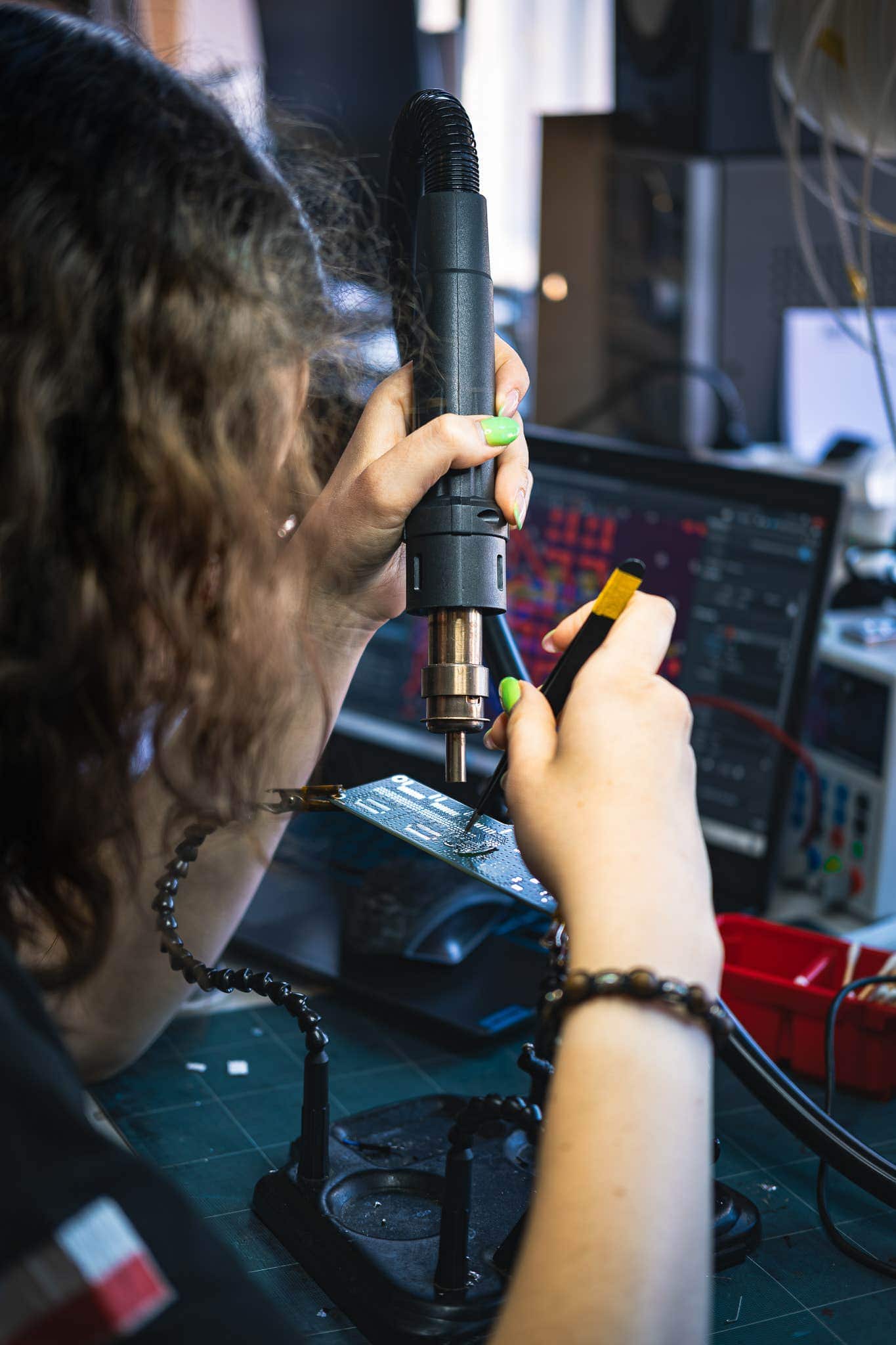 PWR Racing Team member soldering electronics for the RT16e Formula Student Driverless car at Wrocław University of Science and Technology