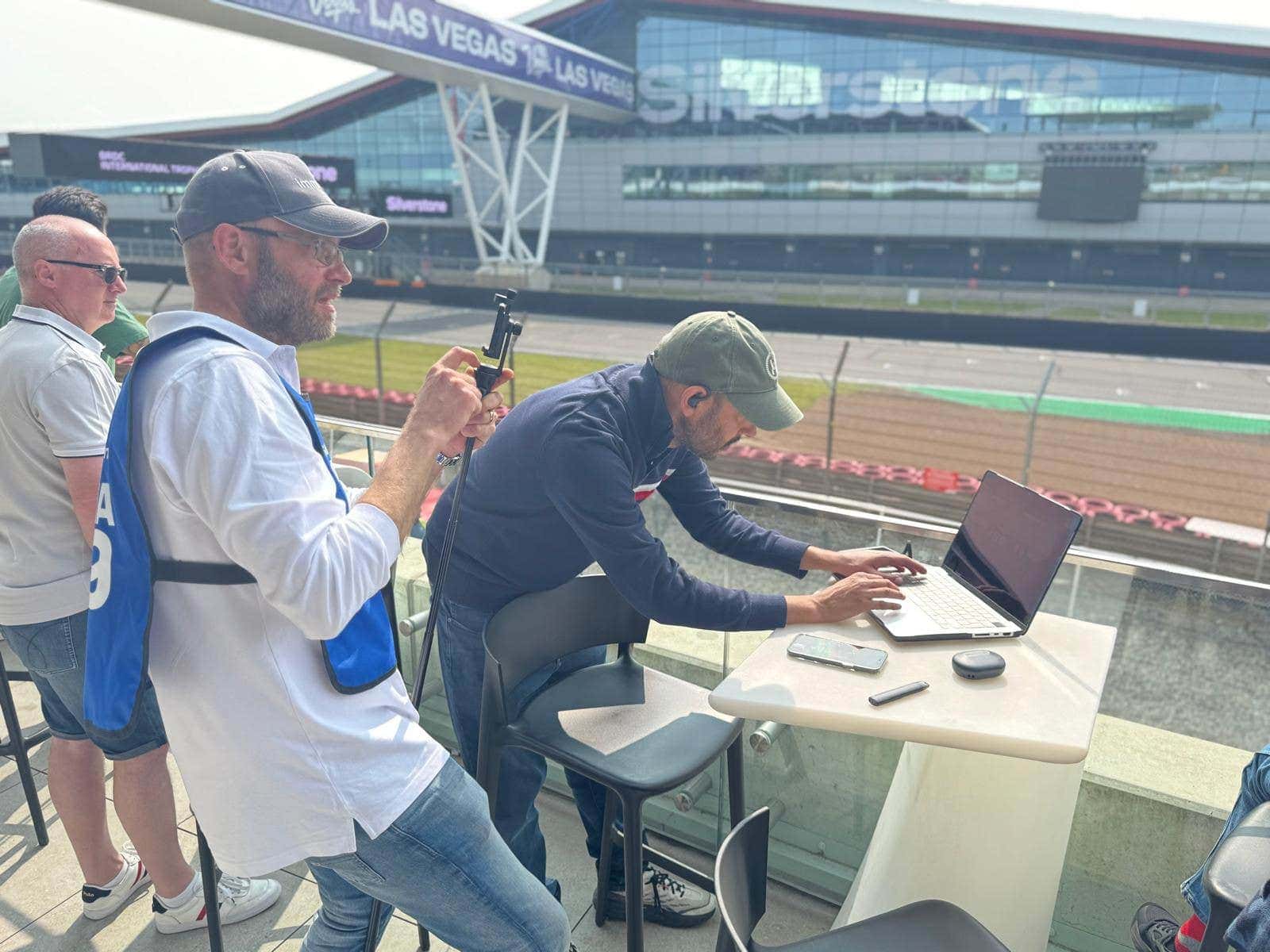 Real-E-Racing team at Silverstone Circuit during the May 2025 proof of concept. Live race car telemetry streamed over 1,000 km to a sim racing rig in Stuttgart using RTK-corrected GNSS positioning